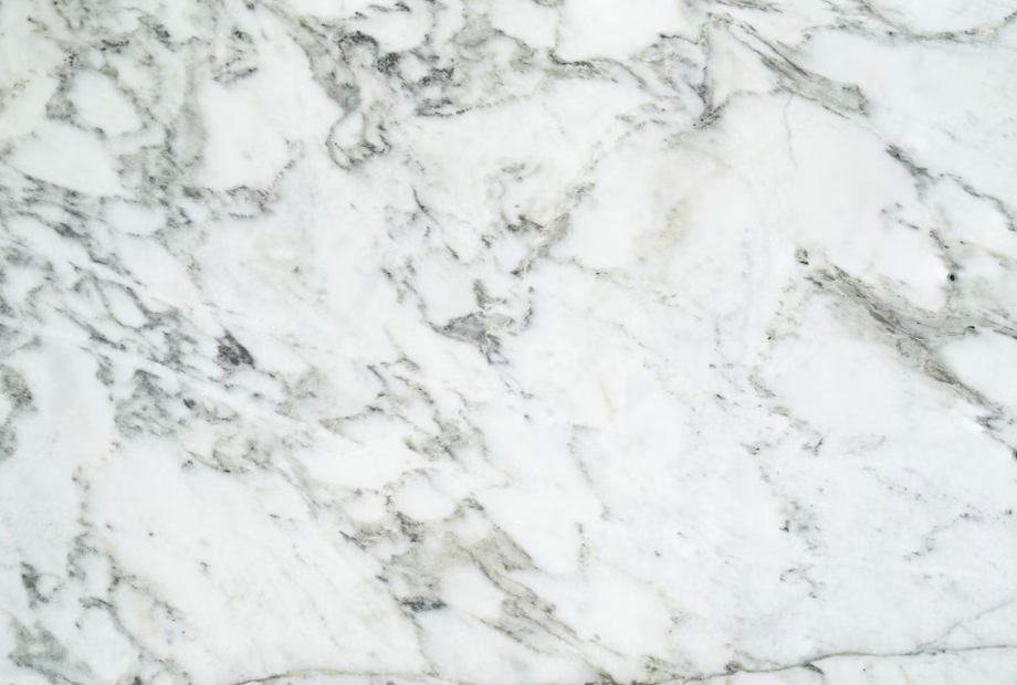 Close-up of white marble with grey and green-grey veining.