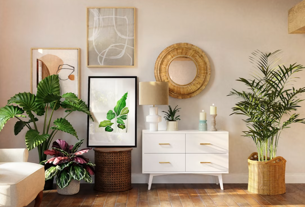 Residential vignette with potted plants, white sideboard, rattan mirror, wood floor.